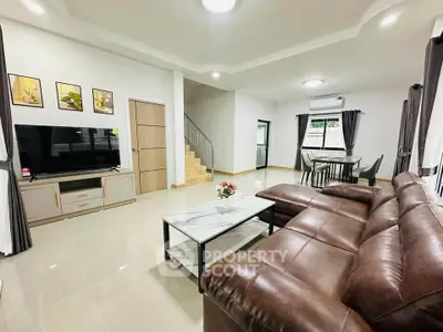 Spacious modern living room with leather sofa and elegant dining area