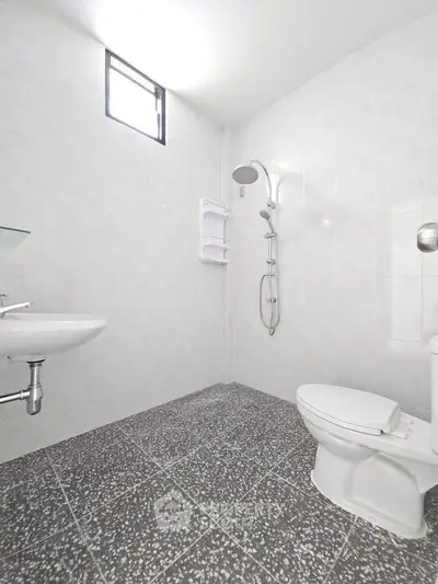 Modern minimalist bathroom with sleek fixtures and tiled flooring