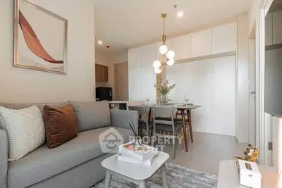 Modern living room with stylish decor and dining area in open layout apartment.