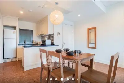 Charming kitchen with dining area, featuring modern appliances and stylish decor.