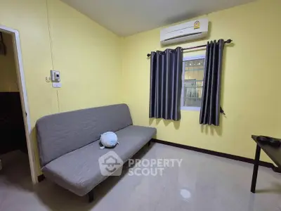 Cozy living room with modern air conditioning and stylish gray curtains, perfect for relaxation.