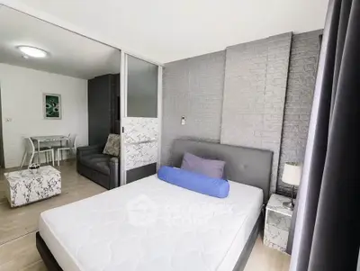 Modern bedroom with stylish decor and sliding glass doors leading to a cozy living area.