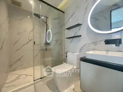 Luxurious modern bathroom with marble tiles and sleek fixtures