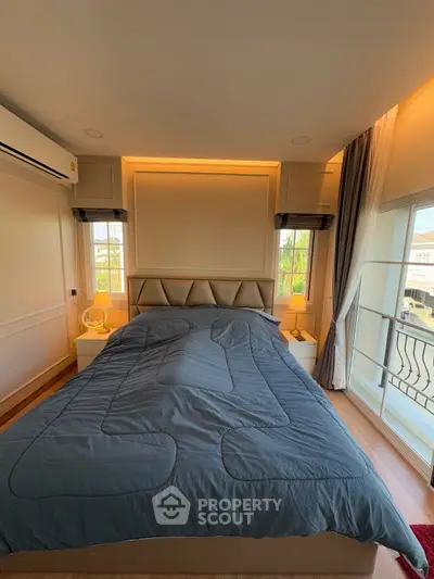 Spacious bedroom with modern design and large windows for natural light.