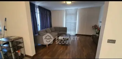 Spacious living room with modern sofa and wooden flooring