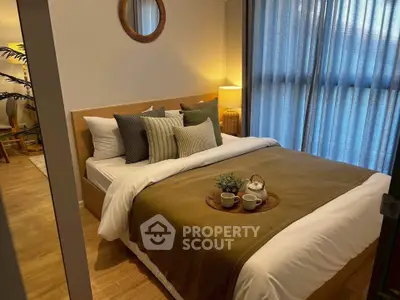 Cozy bedroom with stylish decor and natural light, featuring a comfortable bed and elegant furnishings.