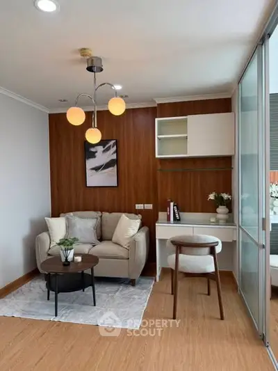 Modern living room with cozy sofa, stylish lighting, and wooden accents for a warm ambiance.