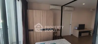 Modern bedroom with large mirror, air conditioning, and stylish wooden furniture.