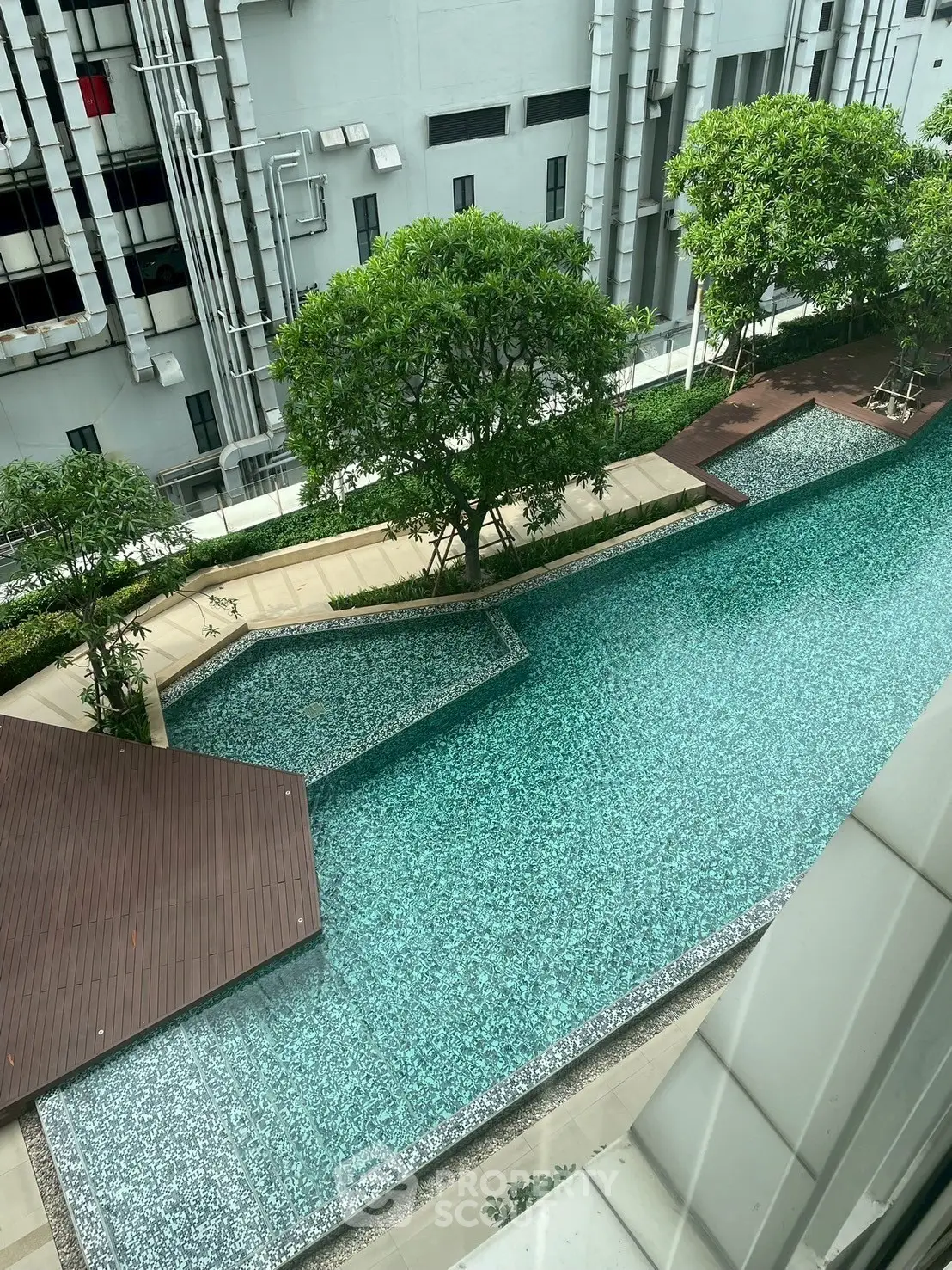 Luxurious residential pool with modern design and lush greenery view