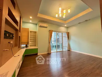 Spacious modern living room with elegant lighting and hardwood floors