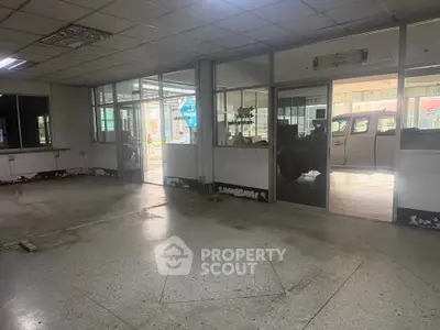 Spacious commercial property with large windows and ample natural light, ideal for business setup.