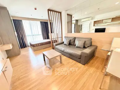 Modern studio apartment with open layout, featuring a cozy living area and stylish bedroom space.