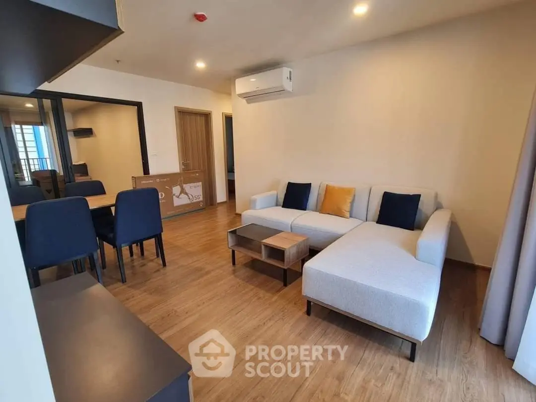 Modern living room with stylish furniture and wooden flooring in a cozy apartment.