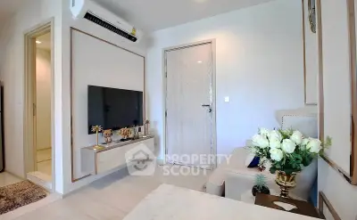 Modern living room with elegant decor and wall-mounted TV, featuring a cozy ambiance.