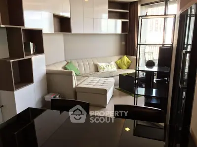 Modern living room with sleek furniture and large windows offering ample natural light.