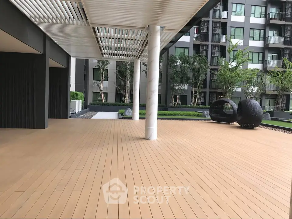 Modern apartment building with spacious outdoor terrace and stylish seating area.
