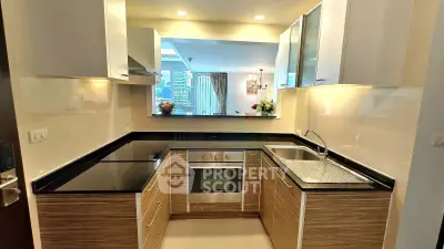 Modern kitchen with sleek cabinetry and built-in oven in a stylish apartment.