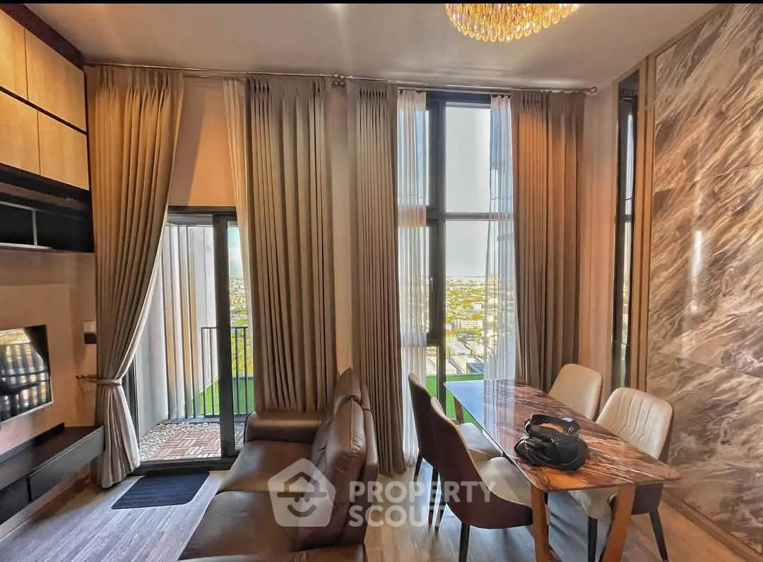 Luxurious living room with elegant dining area and stunning city view from balcony.