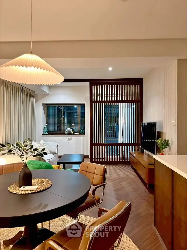 Modern open-plan living room with stylish dining area and cozy seating.