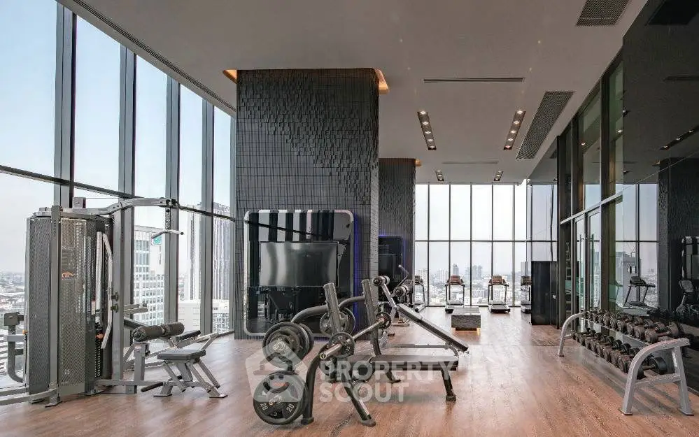 Luxurious high-rise gym with panoramic city views and modern fitness equipment.