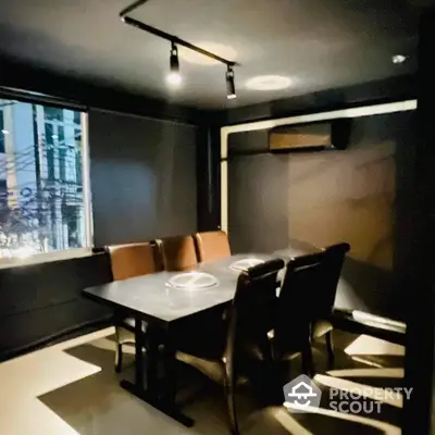 Modern dining area with sleek black decor and stylish lighting