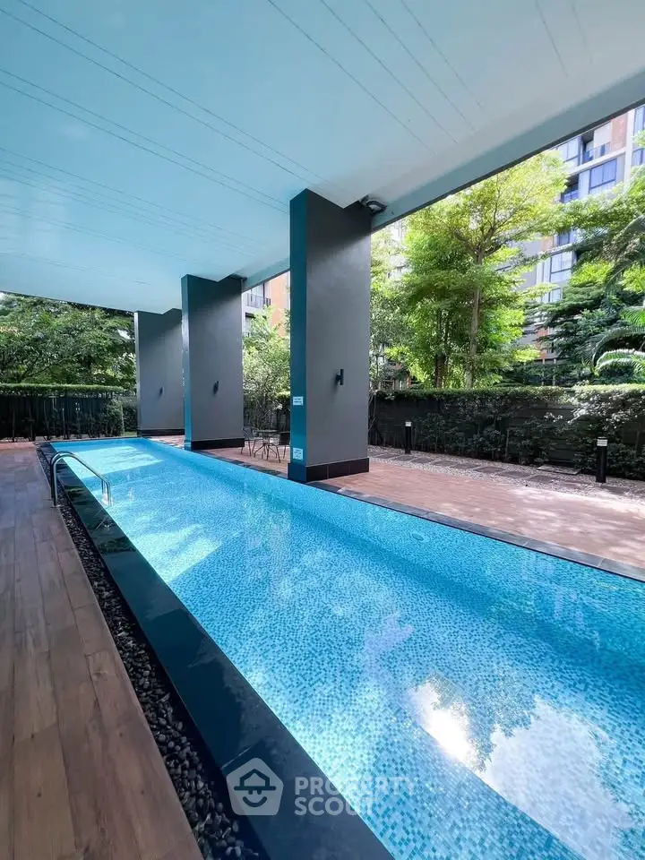 Luxurious modern pool area with sleek design and lush greenery, perfect for relaxation and leisure.
