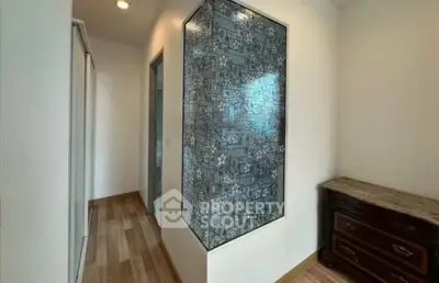 Modern hallway with stylish decor and wooden flooring in a contemporary home.