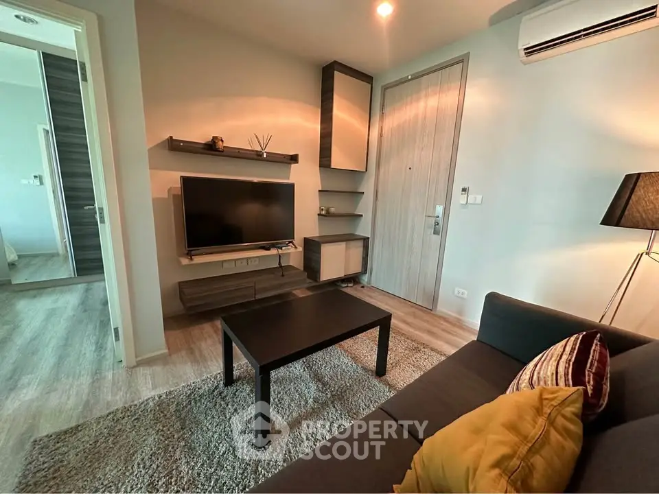Modern living room with sleek furniture and cozy ambiance in a stylish apartment.