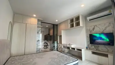 Modern bedroom with built-in storage and TV, featuring a sleek design and neutral tones.