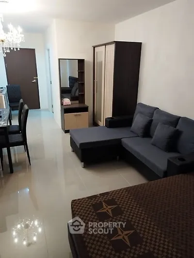 Spacious living room with modern furniture and elegant decor in a cozy apartment.