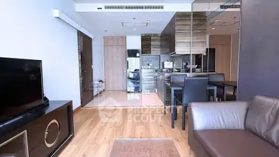 Modern open-layout living room with sleek kitchen and stylish furnishings