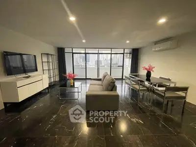 Spacious modern living room with city view, sleek furniture, and elegant decor.