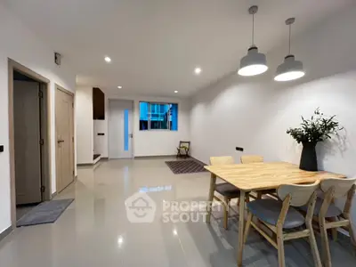 Spacious modern dining area with elegant lighting and minimalist decor