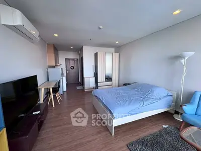 Modern studio apartment with cozy furnishings and wooden flooring