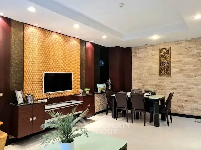 Elegant living room with modern decor and dining area, featuring stylish lighting and textured walls.