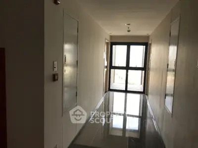 Modern apartment building hallway with glossy floors and natural light