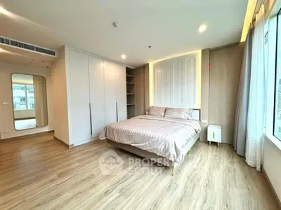 Spacious modern bedroom with elegant design and ample natural light