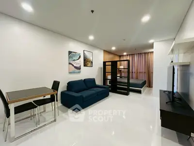 Modern open-plan living room with sleek furniture and stylish decor in a contemporary apartment.