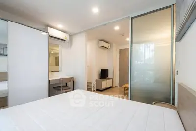 Modern bedroom with sliding glass doors and air conditioning in a stylish apartment.