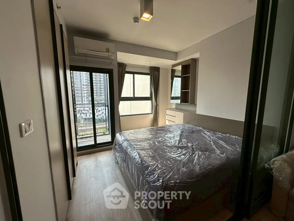 Modern bedroom with balcony view in high-rise apartment