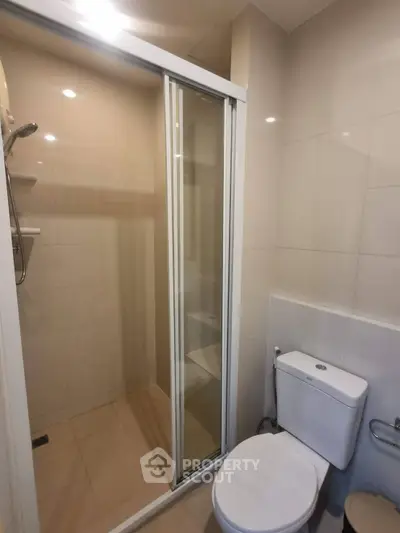 Modern bathroom with shower and toilet in sleek apartment