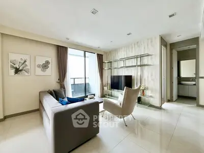 Modern living room with sleek furniture and large windows offering natural light.