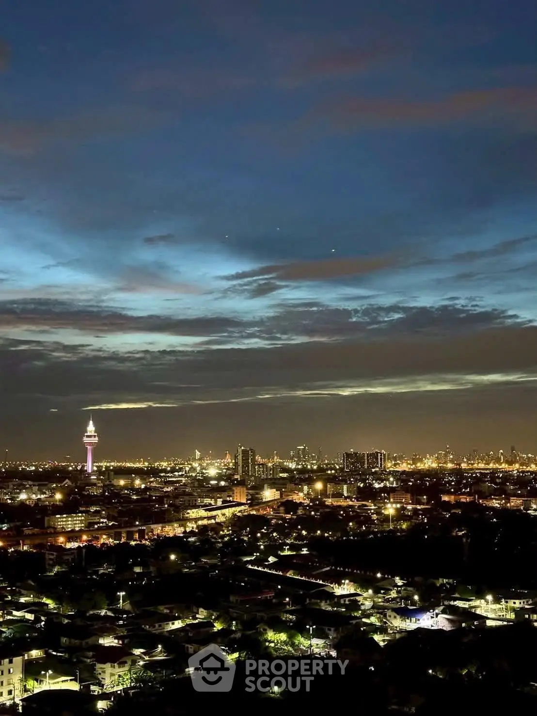 Stunning cityscape view with illuminated skyline and iconic tower at dusk, perfect for urban living enthusiasts.