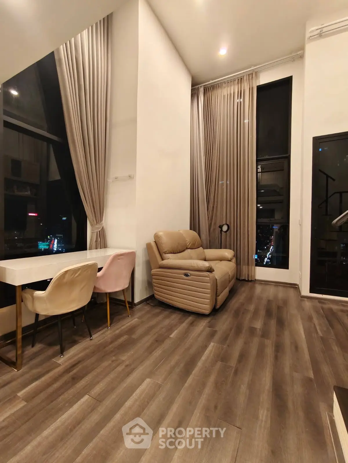 Luxurious high-ceiling living room with modern decor and city view
