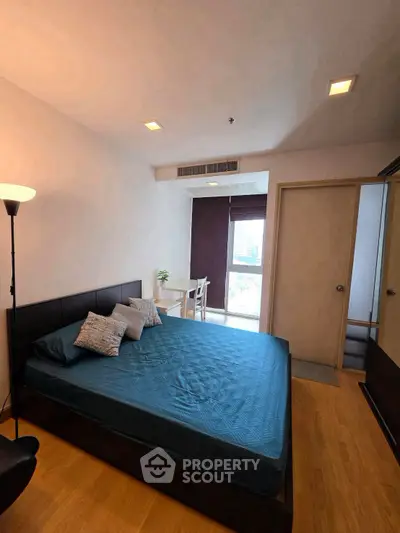 Modern bedroom with stylish decor and natural light in a contemporary apartment.