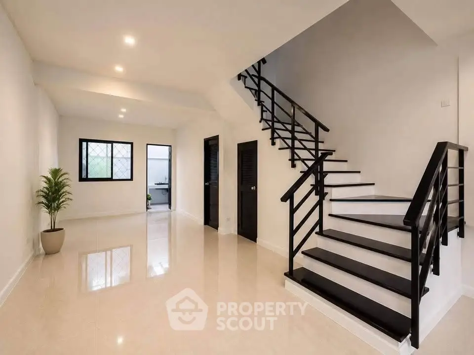 Spacious modern living room with sleek staircase and elegant design