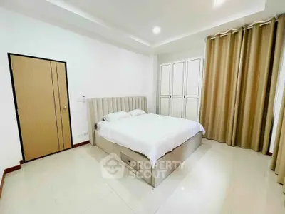 Spacious bedroom with modern design and ample storage in a stylish apartment.