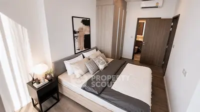 Modern bedroom with stylish decor and cozy ambiance, featuring a comfortable bed and elegant furnishings.