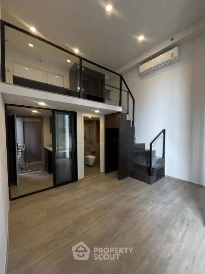 Modern loft apartment with mezzanine, sleek staircase, and open layout for stylish urban living.