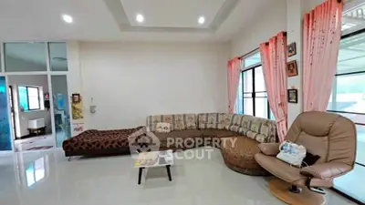 Spacious living room with modern sectional sofa and large windows for natural light.